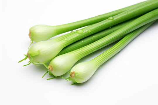 a bunch of green onions on a white surface