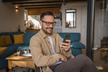 One adult man at home use smart phone app browse internet or send sms