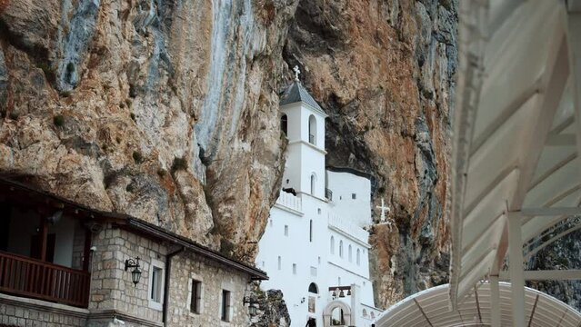 Ostrog Monastery in Montenegro . This pilgrimage place is managed by Serbian Orthodox Church and is situated high up in a vertical rock