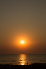 Beautiful sunset near the shore on the sea, background with sunset, orange sunset