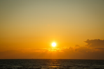 Beautiful sunset near the shore on the sea, background with sunset, orange sunset