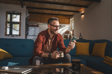 One adult man at home use smart phone app browse internet or send sms - Powered by Adobe
