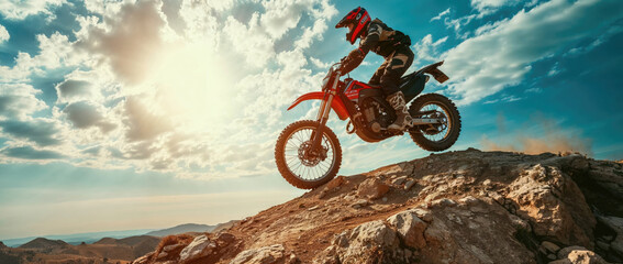 Motorcycle rider jumping on a rock.