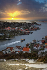 Beautiful typical Scandinavian village, winding around a coastal strip in a bay. Winter environment...