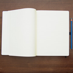 Notebook and pencil on a beautiful background in a large photo studio