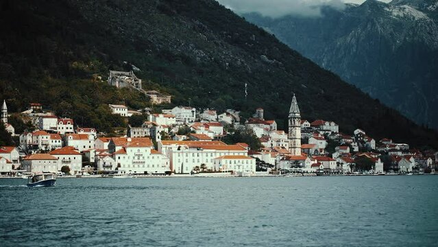 View of the historic town of Perast at famous Bay of Kotor on a beautiful sunny day with blue sky and clouds in summer, Montenegro.