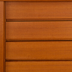 Late-Century teak credenza. Vintage wooden sideboard. Indoor detail photograph. 