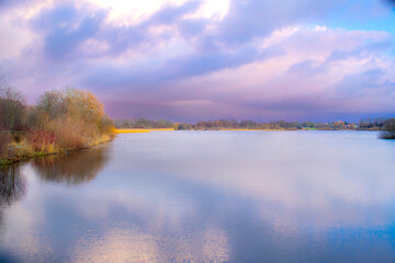 Purple sky over the lake at sunset. Utterslev Mose
