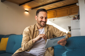 One Man caucasian Holding Digital Tablet work at home Happy Smile