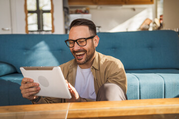 One Man caucasian Holding Digital Tablet work at home Happy Smile