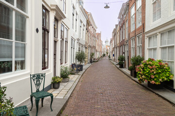 Fototapeta na wymiar Narrow street with planters in the center of the city of Middelburg in Zeeland