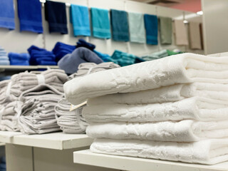 Obraz na płótnie Canvas stack of colorful towels on shelves