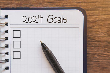 Close up planner with list goals 2024 inscription, planning and motivation concept
