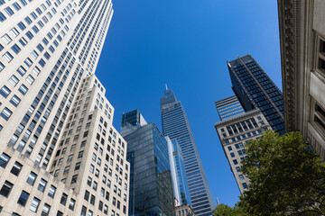 Fototapeta premium Beautiful Buildings and Skyscrapers with a Blue Sky in Midtown Manhattan of New York City
