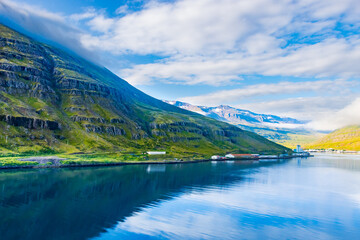 Fototapeta premium Beautiful Green Landscape and Blue Ocean of Seydisfjordur, Iceland cpatured during early morning