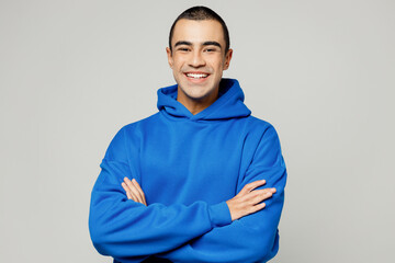 Young smiling happy cheerful middle eastern man he wears blue hoody casual clothes hold satisfied...
