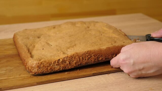 The baked cake is cut lengthwise for the filling