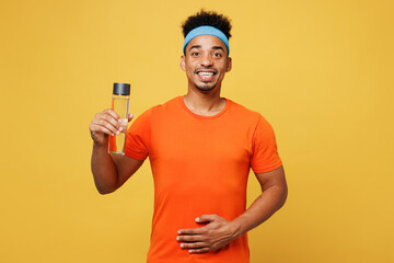 Young fitness trainer instructor sporty man sportsman wear orange t-shirt hold water bottle put...
