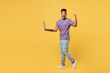 Full body young man of African American ethnicity he wears purple t-shirt casual clothes hold use...