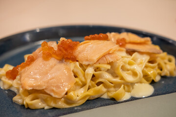 Spaghetti creme sauce with salmon and tobiko or flying fish roe
