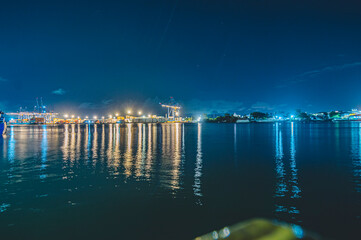 Navegantes Marina, cargo ship moored in Navegantes-SC at night with cranes taking the containers, photo taken from inside the ferry boat