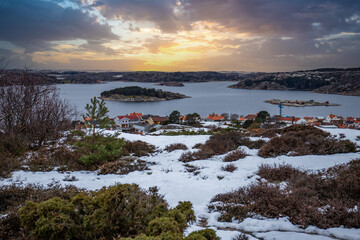 View over a stony coastal landscape in winter. Snow, ice and withered heather. Landscape shot in...