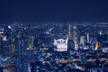 Blurred image bokeh of Bangkok cityscape, night top view in the business district in Thailand.