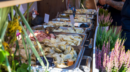 Various type of Polish pierogis or dumpling kept on display for sale in the city center market in...