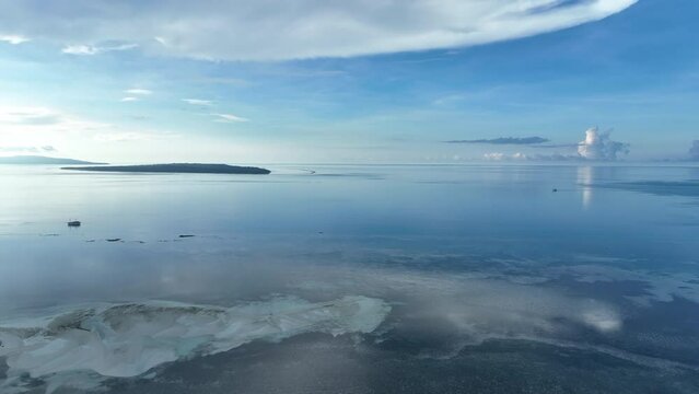 Early morning light illuminates the remote island of Koon near Seram, Indonesia. This scenic island's coral reefs, and the surrounding seas, support extraordinary marine biodiversity.