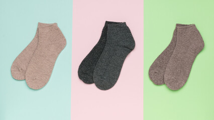 Three pairs of socks on a tricolor background.