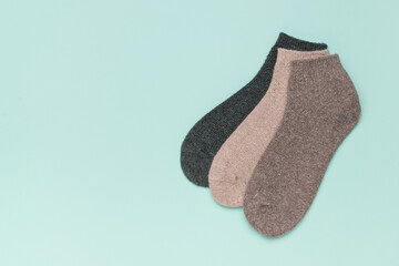 Three colorful socks on a blue background.