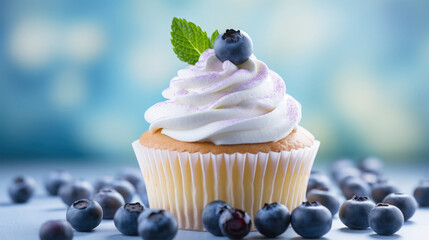 Closeup of dessert of one delicious cupcakes with white cream and berry isolated on blue...