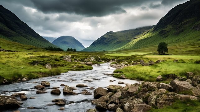 In scotland, a vertical image of a river with mountains and meadows surrounding it.