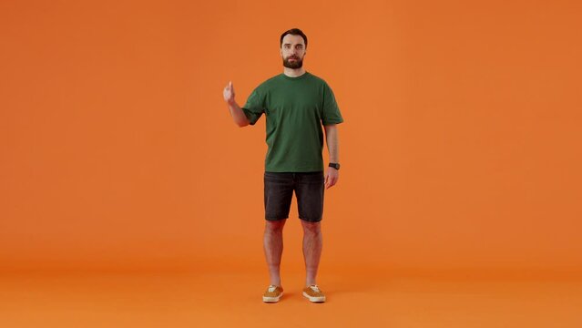 Freezing man dressed in jacket clenching fingers and changing outfit into summer clothes