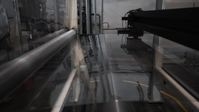 Chemical production of the bopp film. roll of plastic packaging film on the automatic packing machine in food product factory. industrial and technology concept.