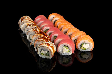 Delicious rolls of Japanese cuisine. Dark background