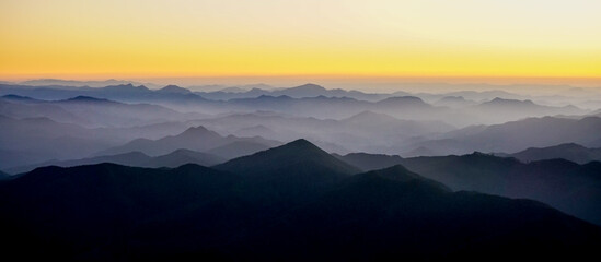 Silhouettes of the Serra da Mantiqueira's mountain range during sunset, seen from Marins Peak....