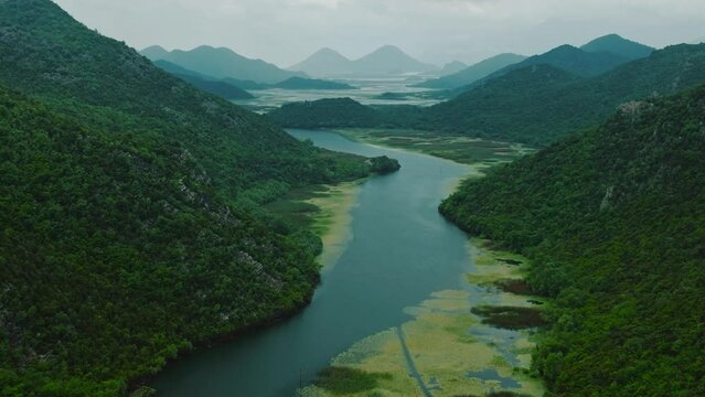 Panorama of mountainous terrain with river valleys. Mountains covered with dense forests. Drone view. Aerial View of National Park Skadar Lake in Montenegro.