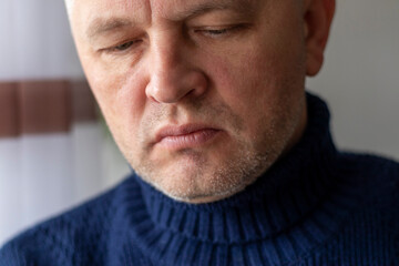 Fototapeta premium Portrait of the mid aged man with grey hair, wearing warm, dark blue sweater. People