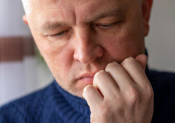 Fototapeta premium Portrait of the mid aged man with grey hair, wearing warm, dark blue sweater. People