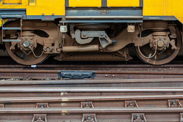 Close Up of train boogie resting in the station with railways on the foreground