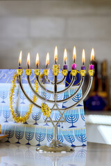 Fototapeta premium Hanukkiah Menorah candle is lit during traditional celebration of Hanukkah it is one symbols Jewish religion during this holiday