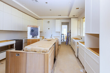 Home improvement assembling of new white kitchen furniture cabinets interior