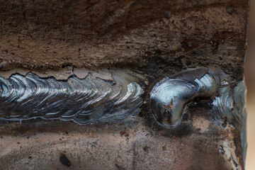 Welding seam on metal close up, welding work with metal