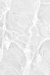 White water with ripples on the surface. Defocus blurred transparent white colored clear calm water surface texture with splashes and bubbles. Water waves with shining pattern texture background.