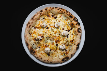Pizza with crispy sides and cheese on a black background