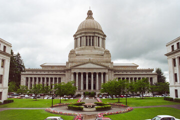 Grainy archival film photograph of the Washington State Capitol Building with cloudy sky.  Shot May...