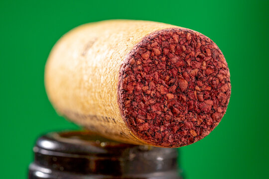 detail of a cork stopper used in a bottle of red wine with a ruby mark absorbed on the contact surface