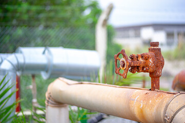 old and rusty faucet of obsolete chemical industrial equipment
