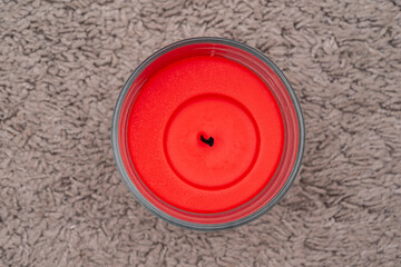 red wax candle with no burning flame